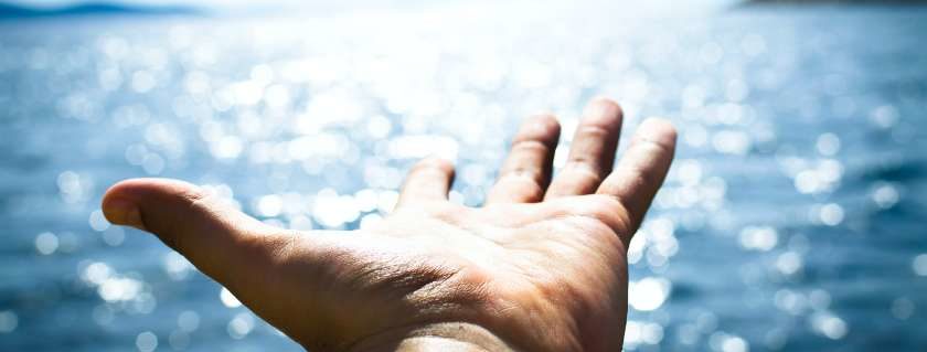 Hand Reaching Out and Prayers for a Miracle