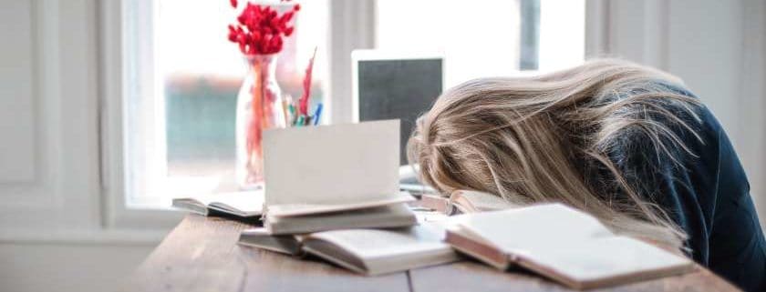 girl laying her head on top of books on the table and mindfulness activities for students
