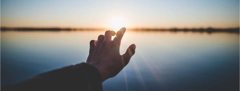 hand reaching out to the sun and righteousness of god