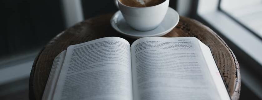 having a cup of coffee while looking for the 22 meaning bible