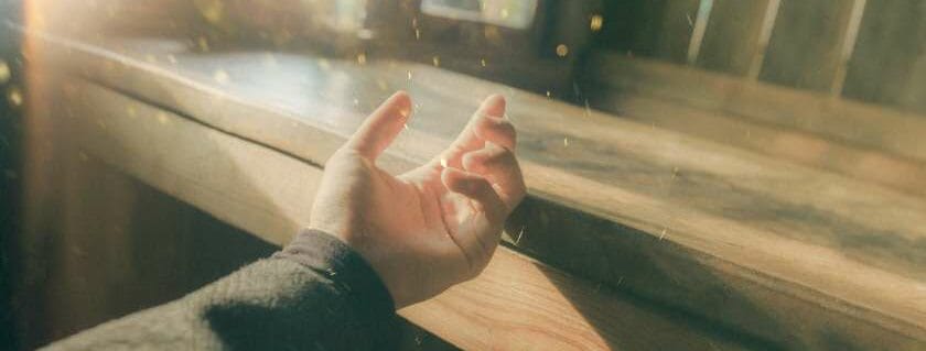 left arm and hand with light leaks and list of the promises of god