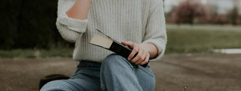 lady sitting and holding bible and apply the word of god