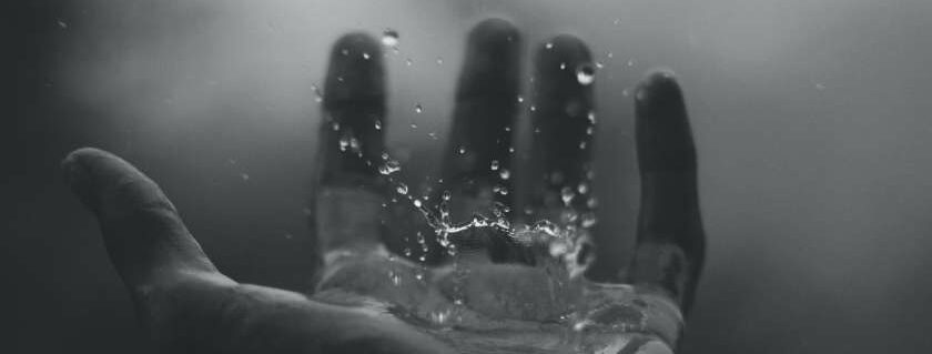 water splashing on hand and born of god