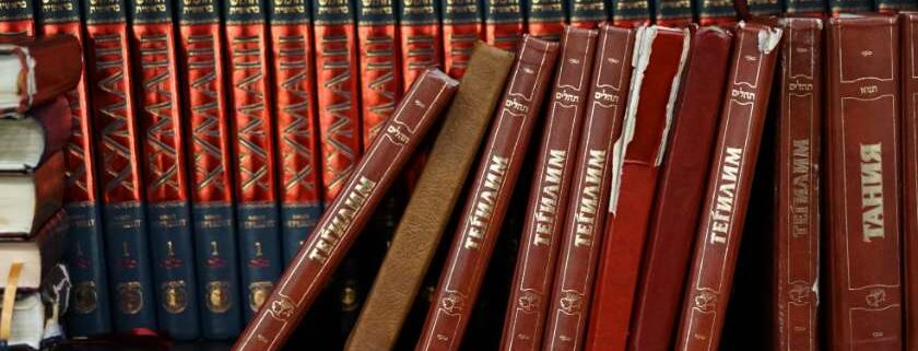 old books on bookshelves and leaning against each other