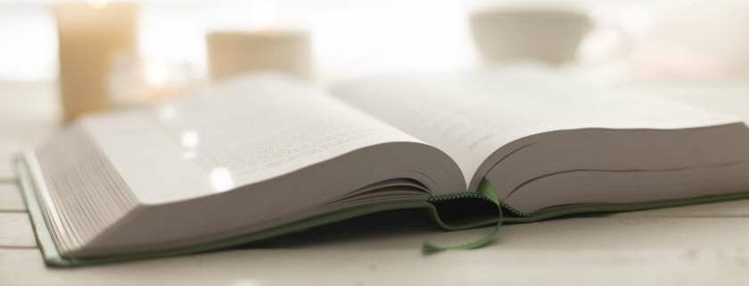 open book against white background with green bookmark